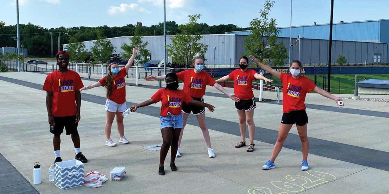 A group of people with red JumpStart shirts on