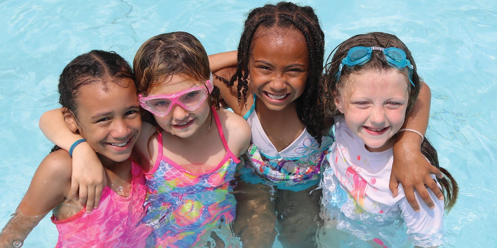 a group of kids in a swimming pool